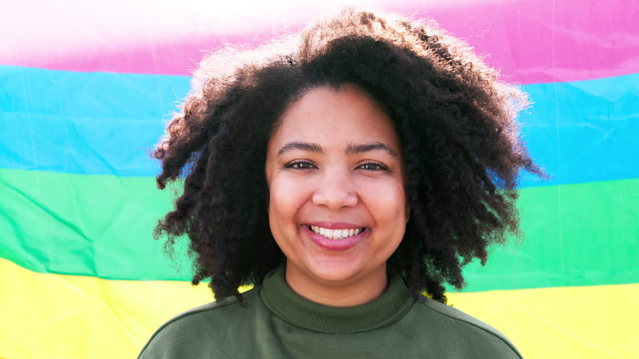 African woman, pride and rainbow flag