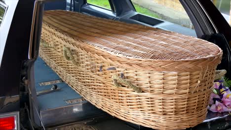 closeup shot of a funeral casket in a hearse or chapel or burial at cemetery