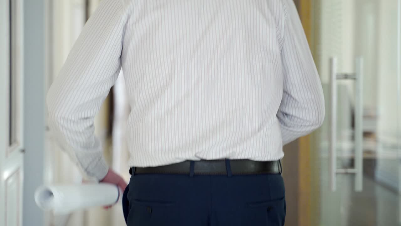 an employee with papers is running along the corridor to his workplace. Late to office