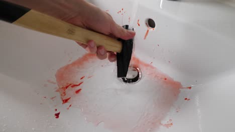 a bloody murder weapon being washed by serial killer, 4k, fake blood