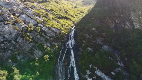 Drone-Aéreo-Cerca-De-La-Cascada-De-Robo,-Ben-Nevis,-Agua-De-Escocia-Cayendo-En-Un-Escenario-Verde-Y-Exuberante