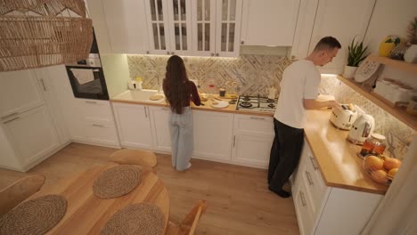 loving couple making a sandwich in kitchen-living room