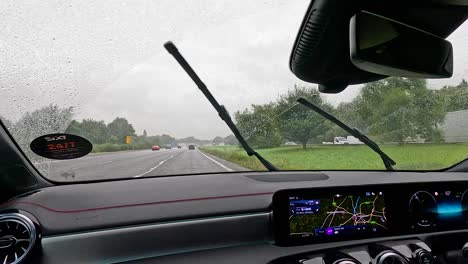 car navigating wet roads alongside a large truck