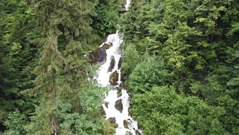 the beautiful rocky green mountain waterfall in obersee switzerland - wide