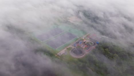 floating solar panels, water treatment facility emerge through thick fog, latvia
