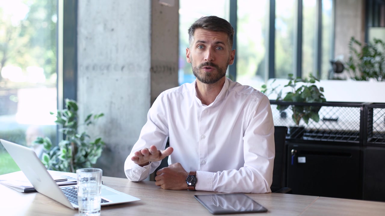 Professional Businessman Talking and Gesturing During Video Call