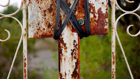 an old rusty fence with a lock tied and wired shut to discourage trespassers - grunge look