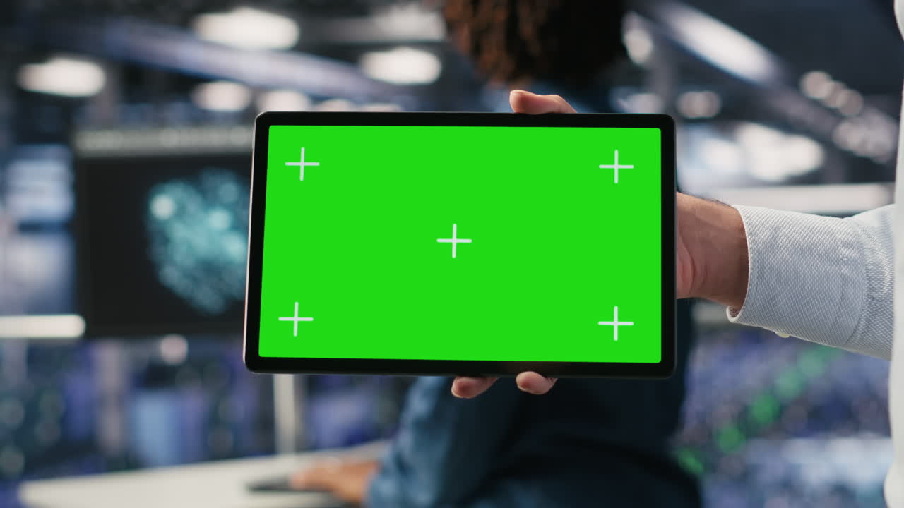Close up of server room worker using isolated screen device