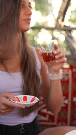 woman enjoying a cup of turkish tea outdoors