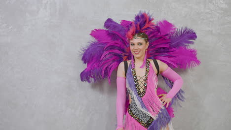 beautiful happy female dancer practicing in a pink and purple gown