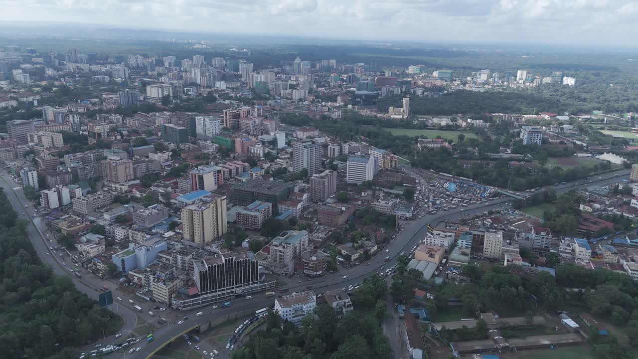 A beautiful aerial drone footage of the cityscape of Nairobi, Kenya, showcasing urban office spaces, modern residential areas, the Nairobi Expressway, and Waiyaki Way. Captured during the day