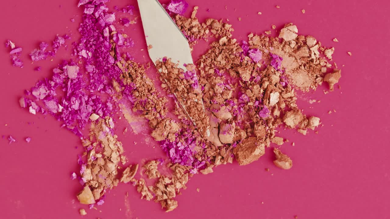 Crumbled Makeup Powder on a Pink Surface