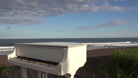 white piano on the beach