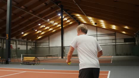 man playing tennis indoor