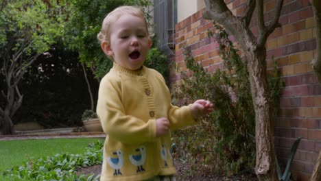 caucasian baby running in the garden