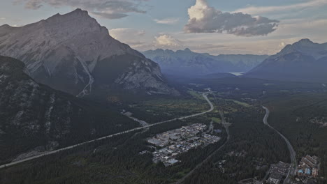 banff ab canada aerial v3 high altitude drone flyover town, capturing panoramic view of cascade mountain landscape, lush dense forests and valleys from above - shot with mavic 3 pro cine - july 2023