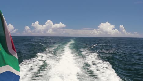 a shot of a long water wake created by the catamaran's engines