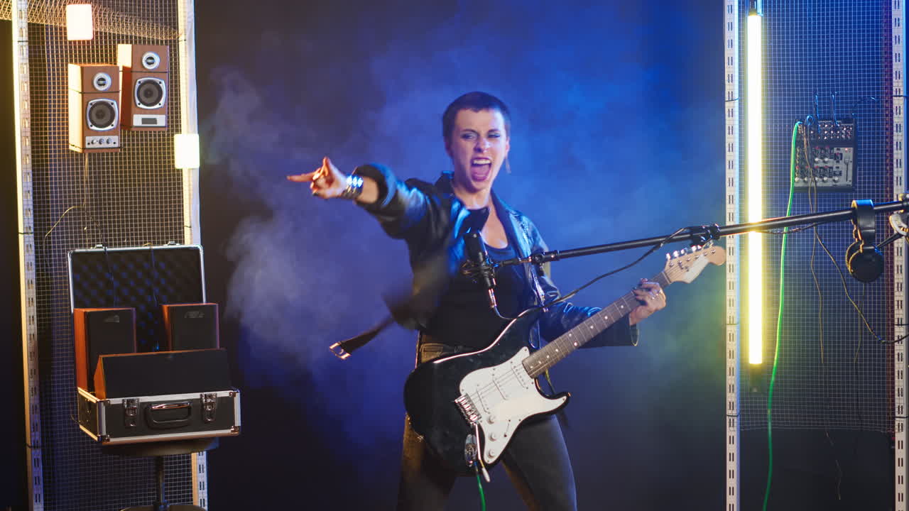 Female musician playing guitar on stage