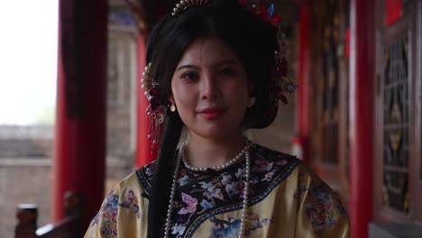 portrait of chinese girl with traditional qing dynasty dress smiling at camera