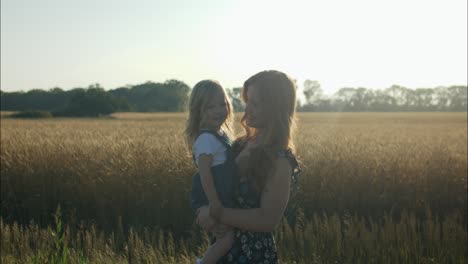 Silhouette-of-a-happy-mother-and-daughter-playing,-laughing,-smiling-together-outside-in-summer-sunset-having-positive,-loving-family-or-mothers-day-moment-showing-joys-of-motherhood