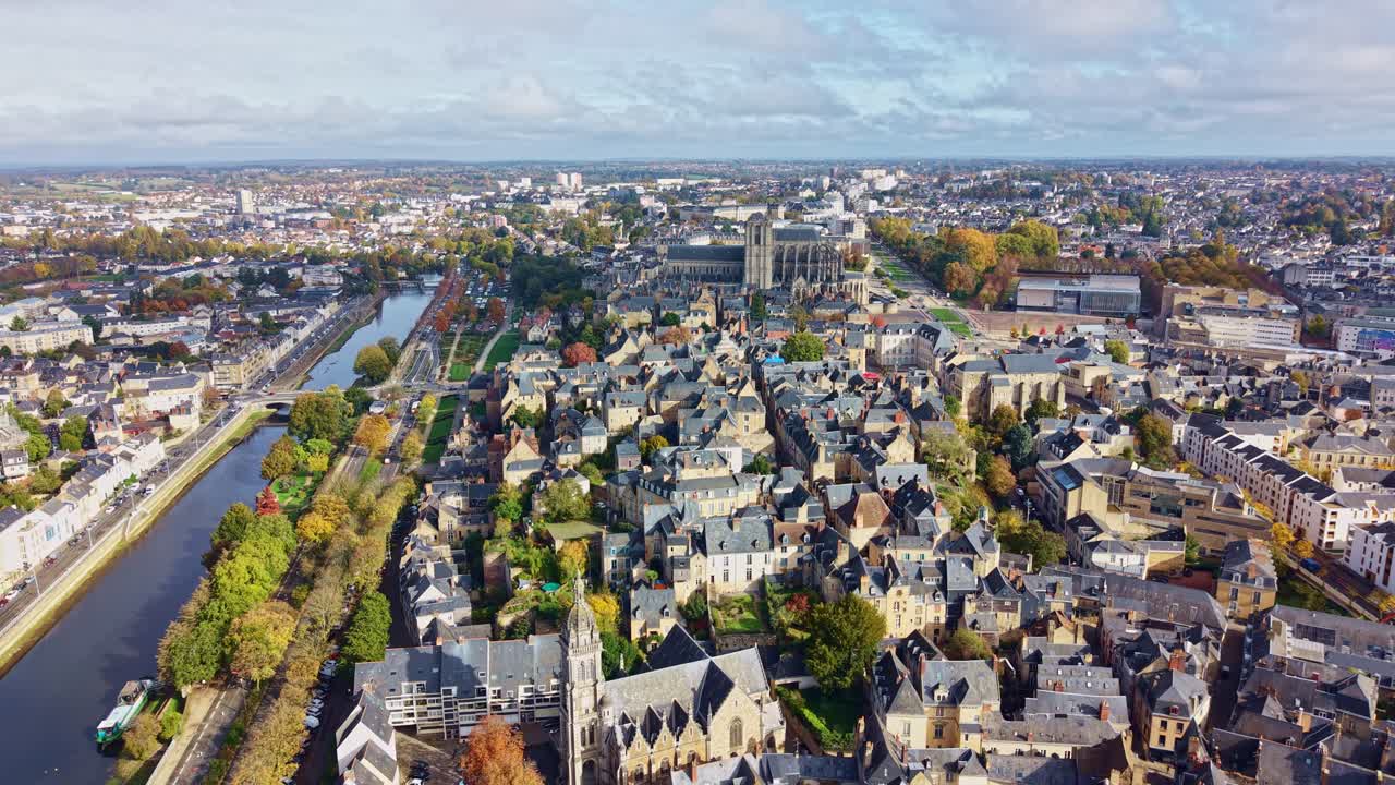 Backward drone fly over Le Mans city skyline with gothic Le Mans Cathedral near Sarthe River, France
