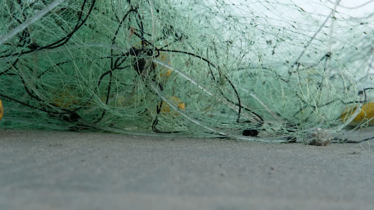 Rete da pesca abbandonata su una spiaggia sabbiosa.