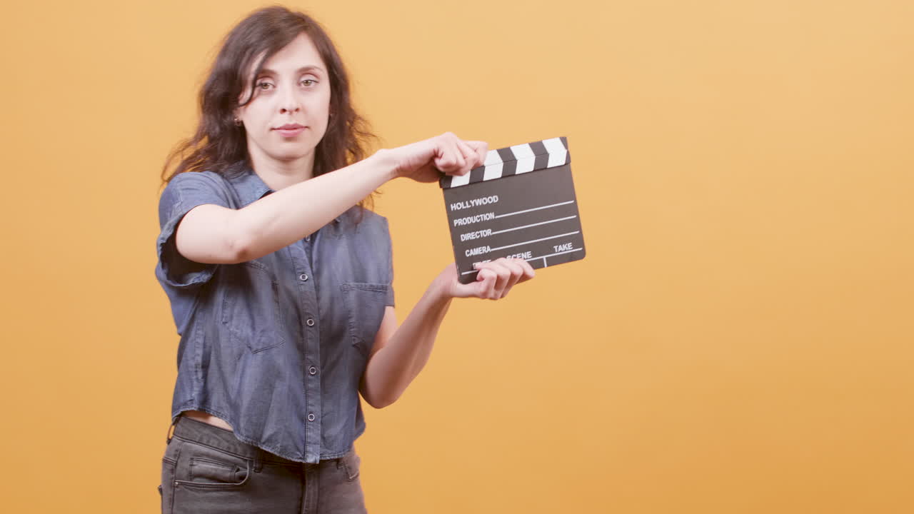 Woman holding a clapperboard