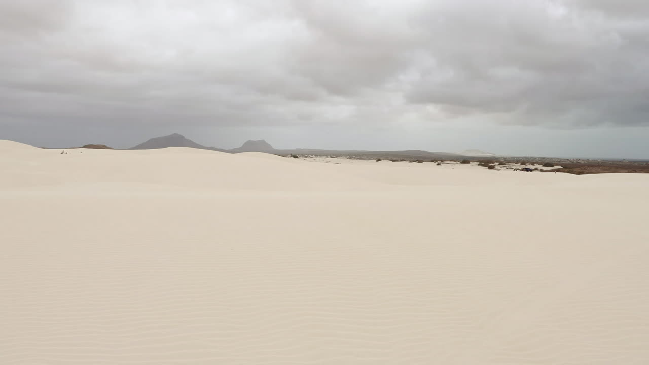 Wonderful sand dunes in Viana desert close up at overcast day, background mountains, Boa vista , Cape Verde