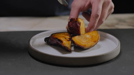 slow motion shot of a chef plating a gourmet sweet potato dish in a restaurant