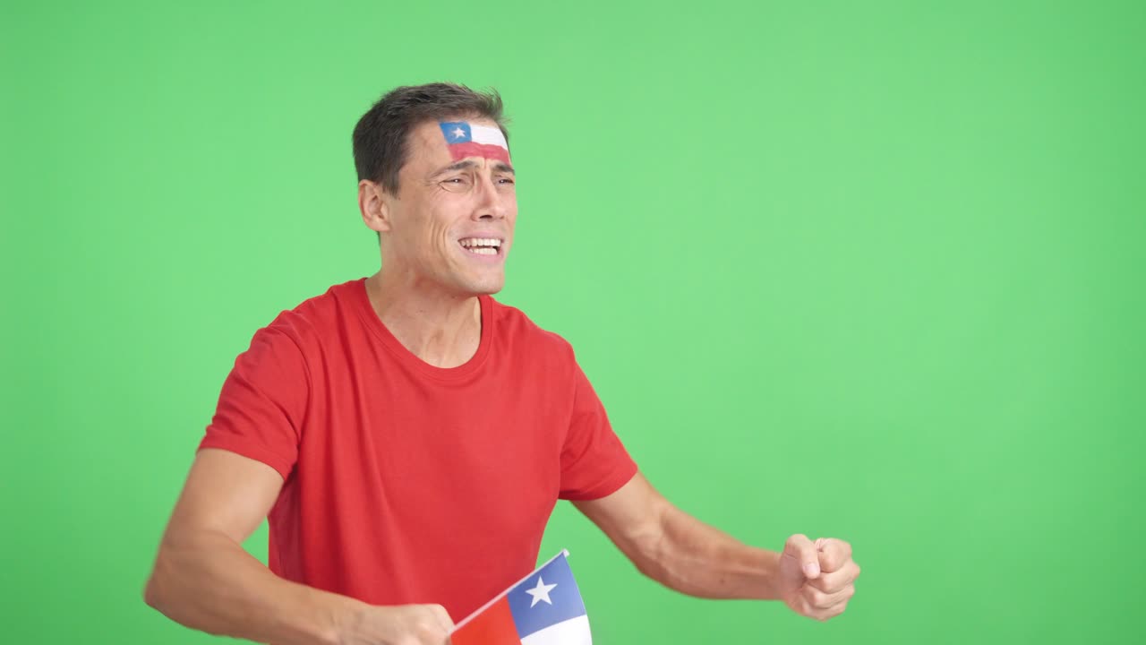 Nervous man cheering for Chile during a match looking away