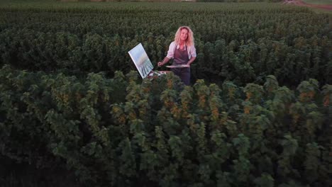 artist girl paints a picture outdoors