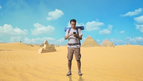 tourist using smartphone in egyptian desert