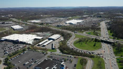 4k aerial drone footage of industrial shopping centers and strip malls in middletown new york and traffics can be seen with mountains in the background