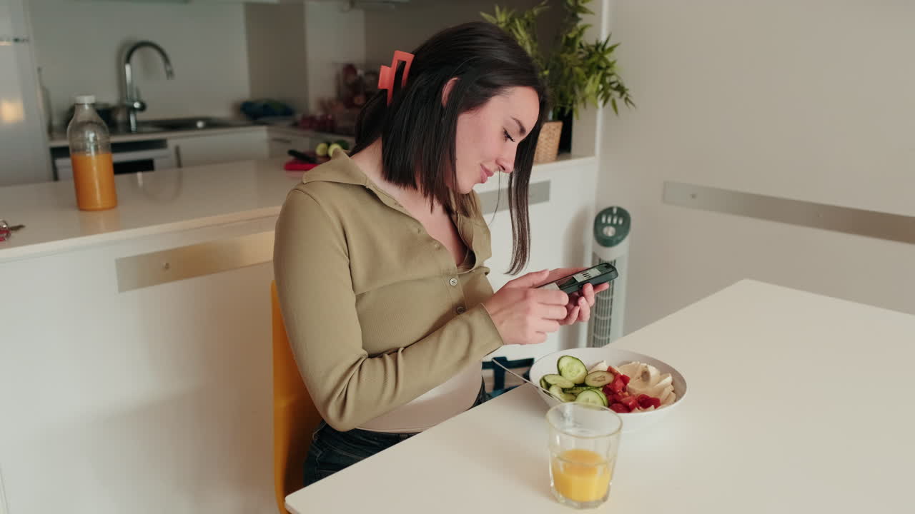 Woman Enjoys Healthy Breakfast and Phone