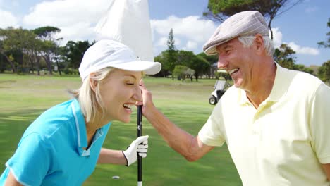 happy golf players laughing together