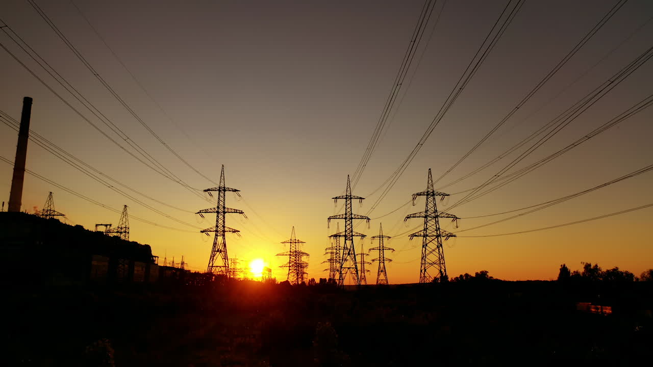 High voltage towers. High voltage power lines during sunset