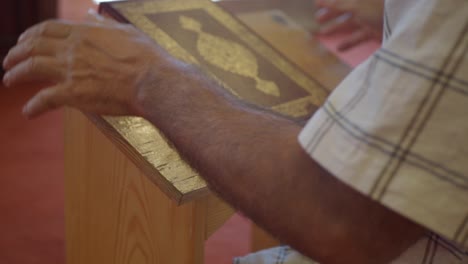 a man reading a religious book during a church service