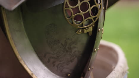 close-up of a roman helmet with a scorpion design