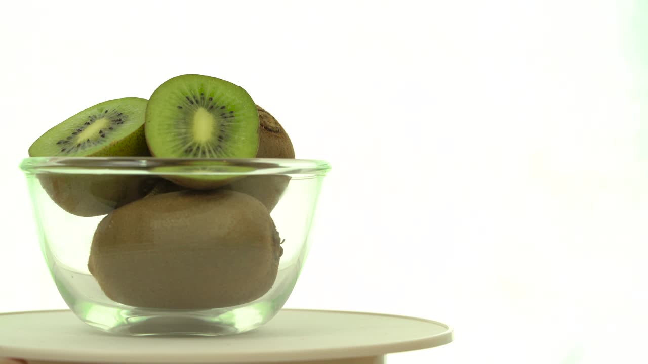 colocar uma tigela de kiwis verdes frescos, a tigela girando