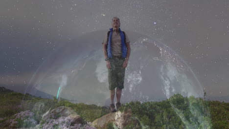 man standing atop rocky hillside, using technology hologram globe for data visualization at night