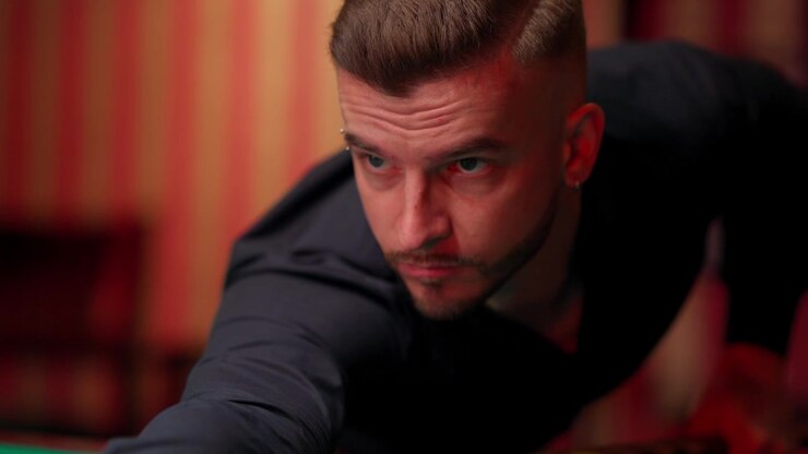 Close-up of a Man Concentrating on a Pool Shot