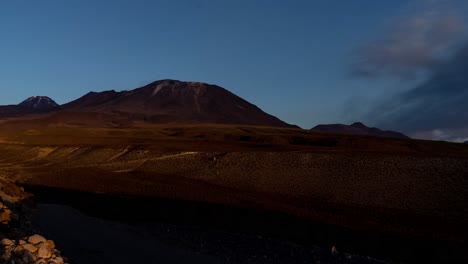 lascar and licancabur volcano timelapse in atacama desert at sunset, south america, chile
