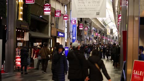 pedestrians walking through a busy shopping arcade