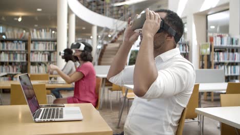 smiling young man wearing virtual reality glasses