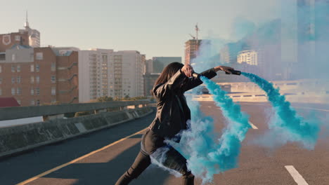 girl dancing with blue smoke grenade in city street young woman hip hop dancer celebrating creative expression with dance slow motion