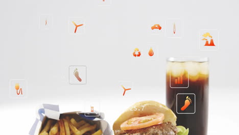 animation of floating digital icons above burger, fries, and soda on table