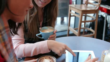 pretty friends enjoying coffee in cafe