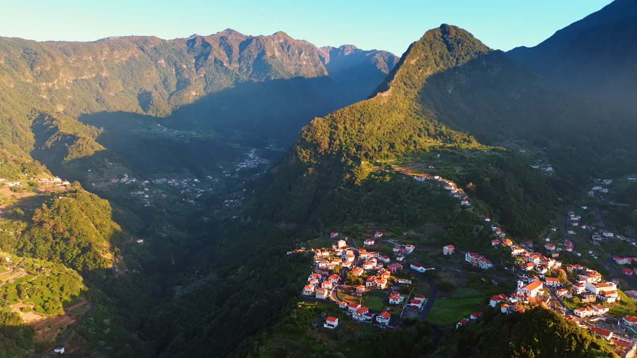 Village located in the mountainous area at the Madeira islands, Portugal. Tops of the mountains are lit with sun.