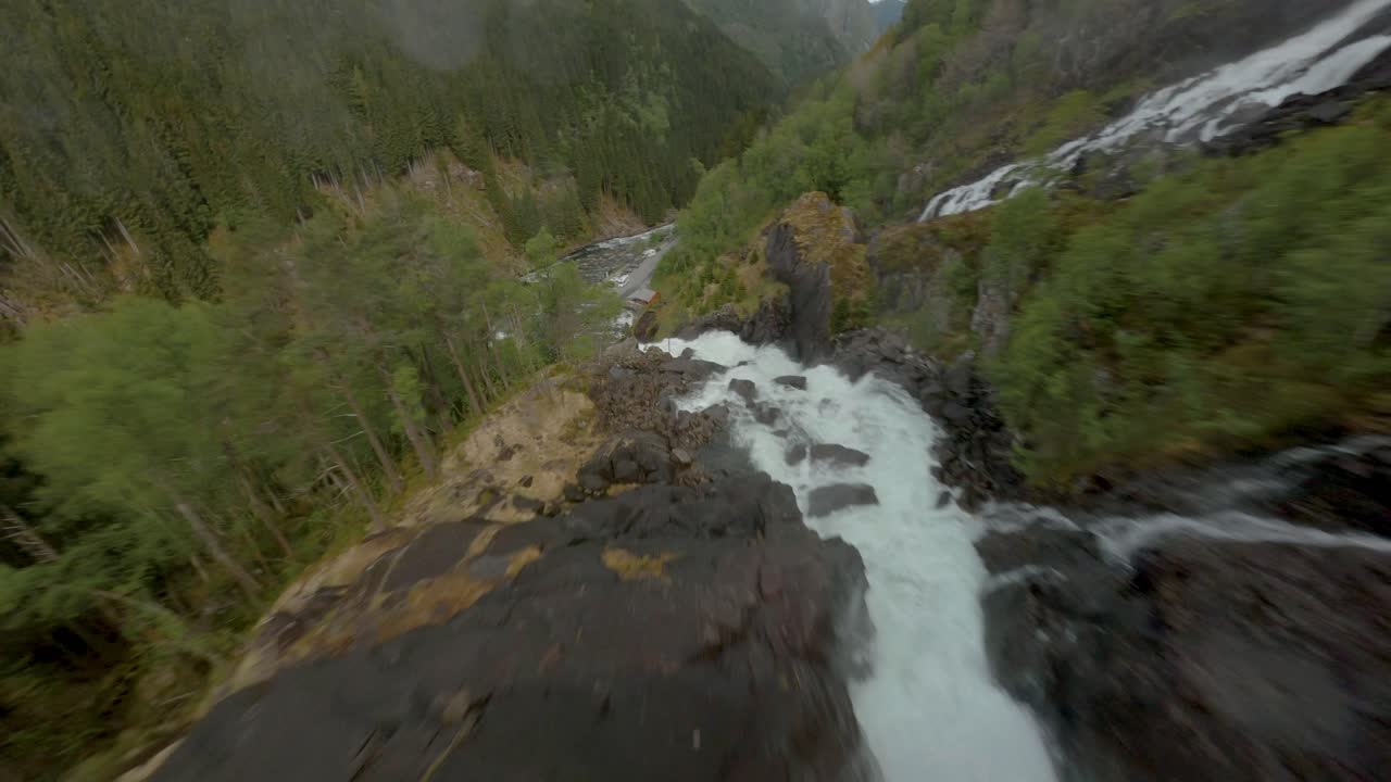 vuelo aéreo de drones cuesta abajo cascada de låtefoss hacia el valle en noruega