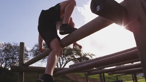 young man training at an outdoor gym bootcamp